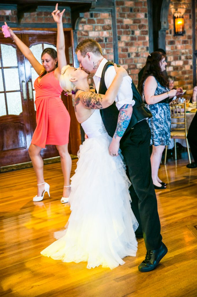 Bride and groom kissing on dance floor at Riviera Waterfront Mansion wedding