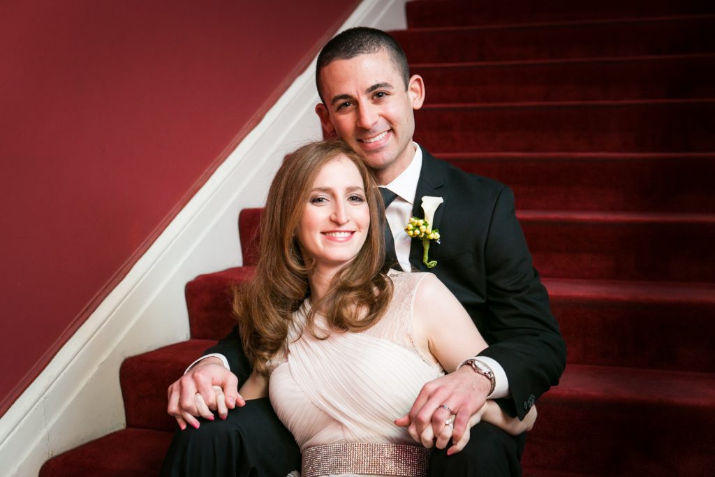 Harvard Club wedding photos of bride and groom sitting on stairs