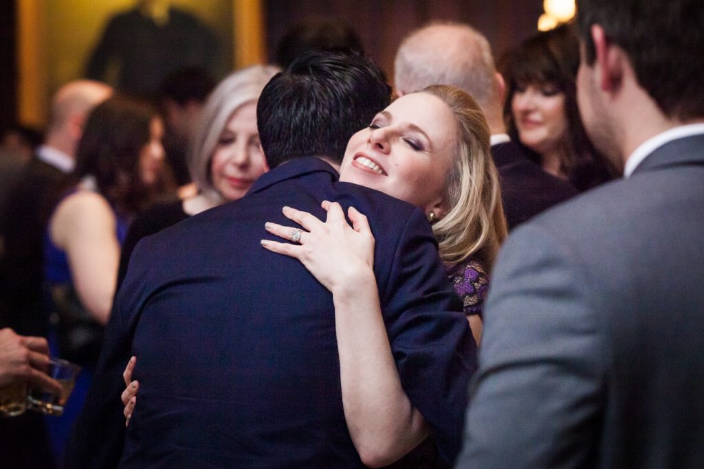 Harvard Club wedding photos of woman hugging guest