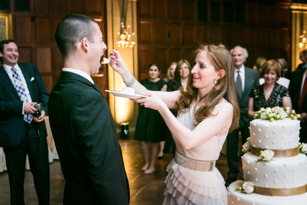 Harvard Club wedding photos of bride feeding cake to groom