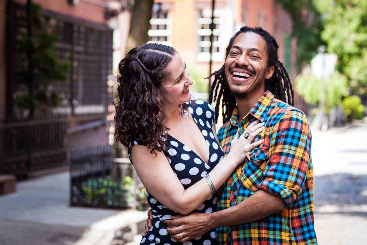 Meatpacking District engagement photos of couple laughing on a Greenwich Village street