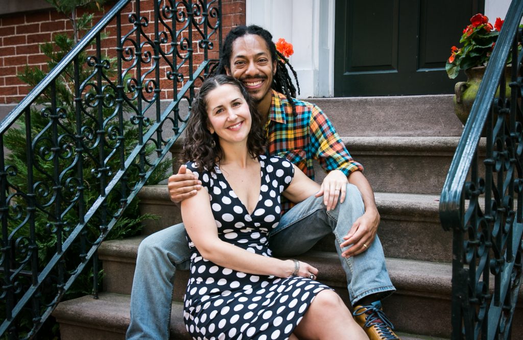 Meatpacking District engagement photos of couple sitting on apartment steps