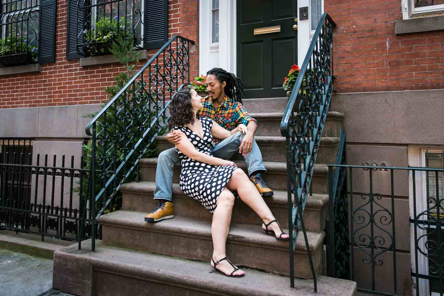 Meatpacking District engagement photos of couple sitting on brownstone steps