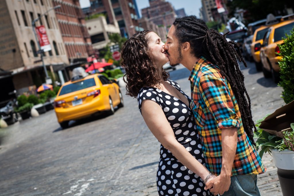 Couple kissing on Meatpacking District street with taxi in background