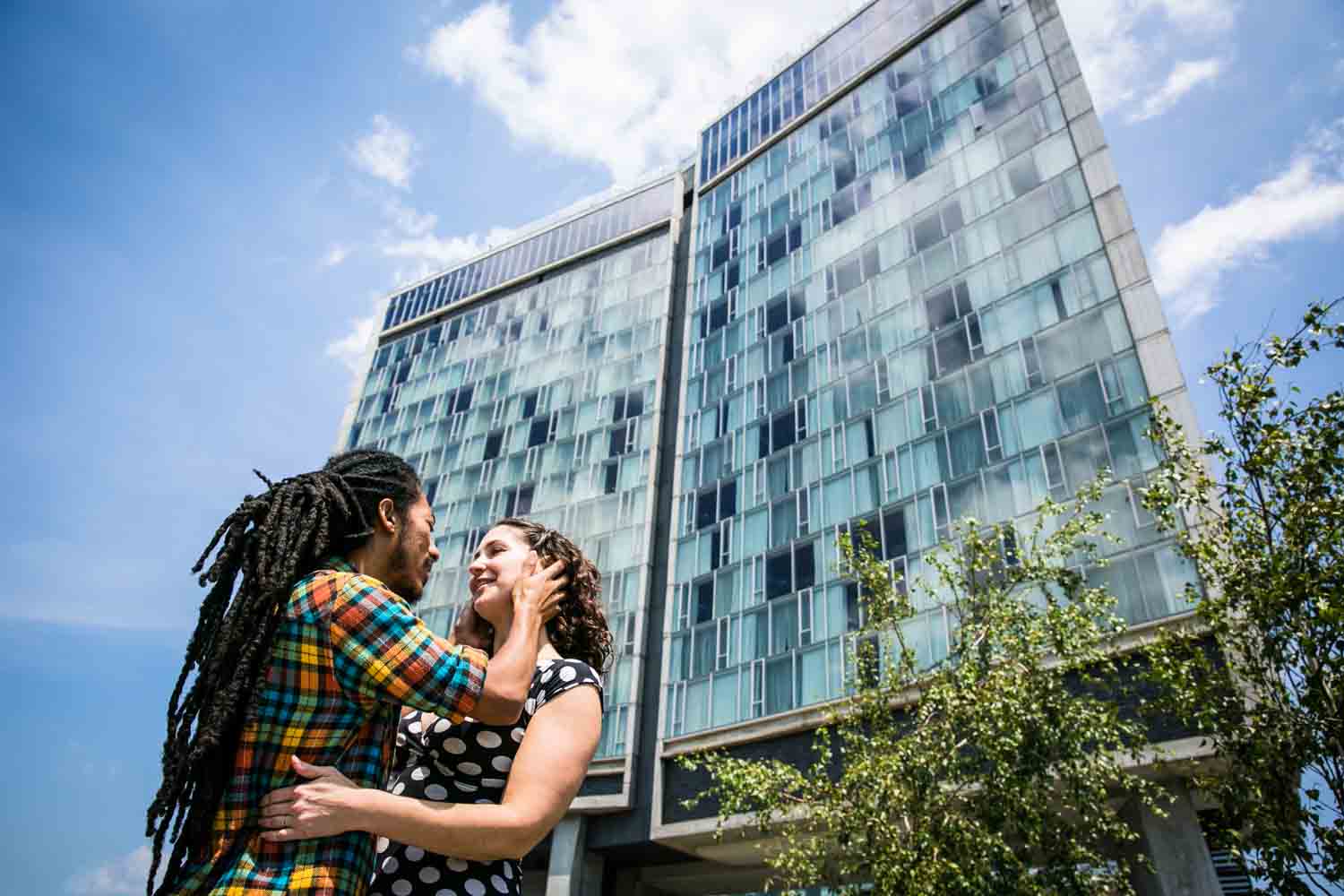 Man touching woman's face with Standard Hotel in background