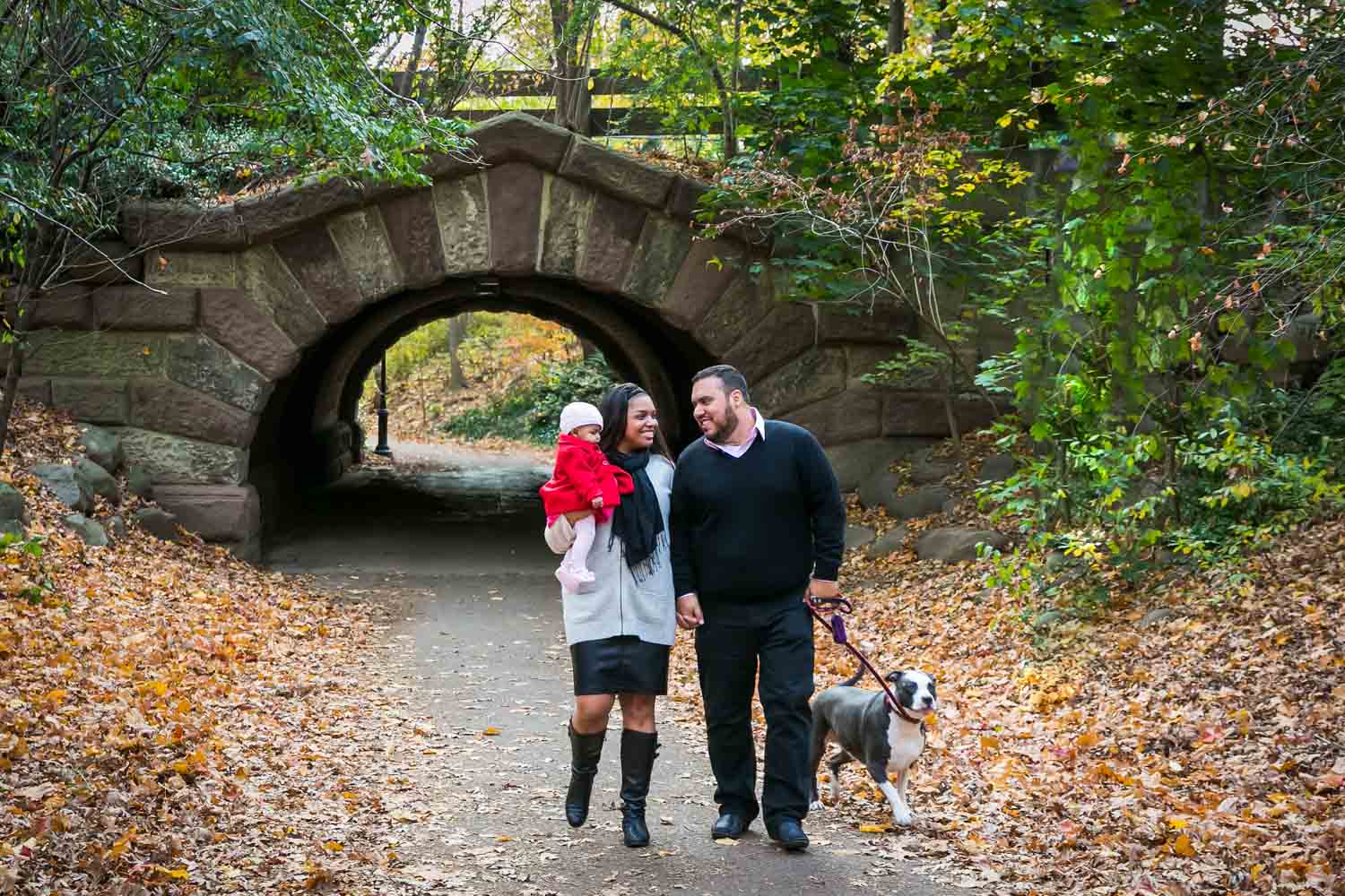 Prospect Park family portrait of family walking in front of arch in park