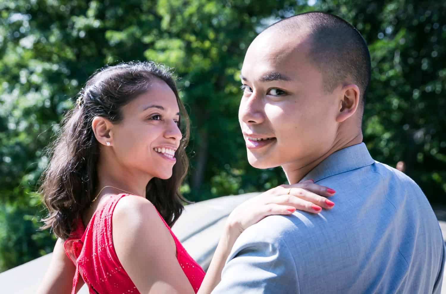 Couple walking in Central Park turning to look into camera