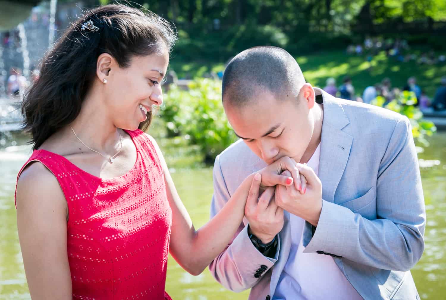 Man kissing woman's hand at Bethesda Fountain