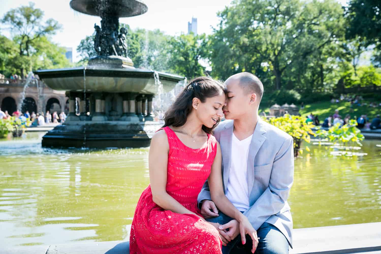 Man kissing woman beside Bethesda Fountain