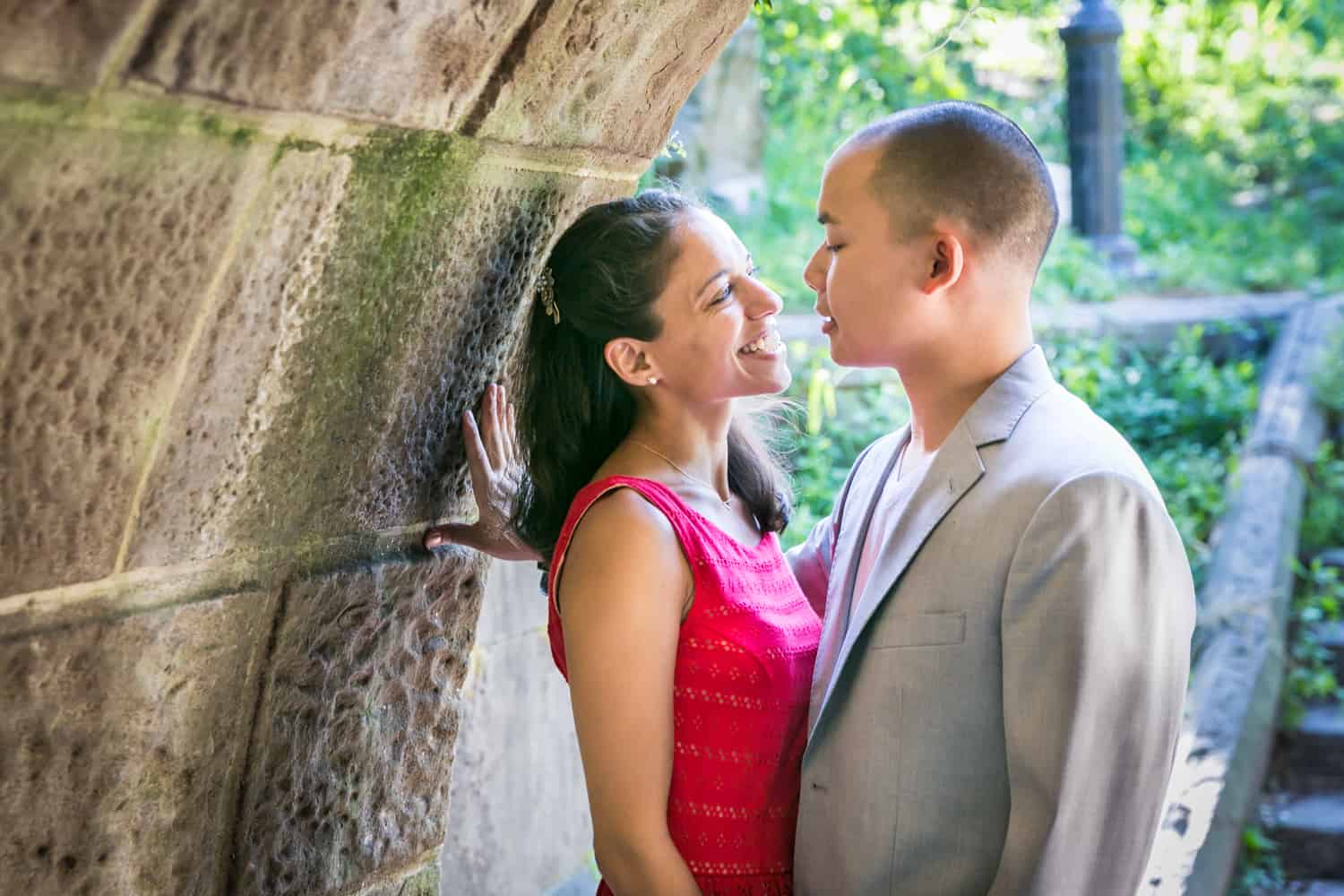 Couple hugging under Trefoil Arch in Central Park
