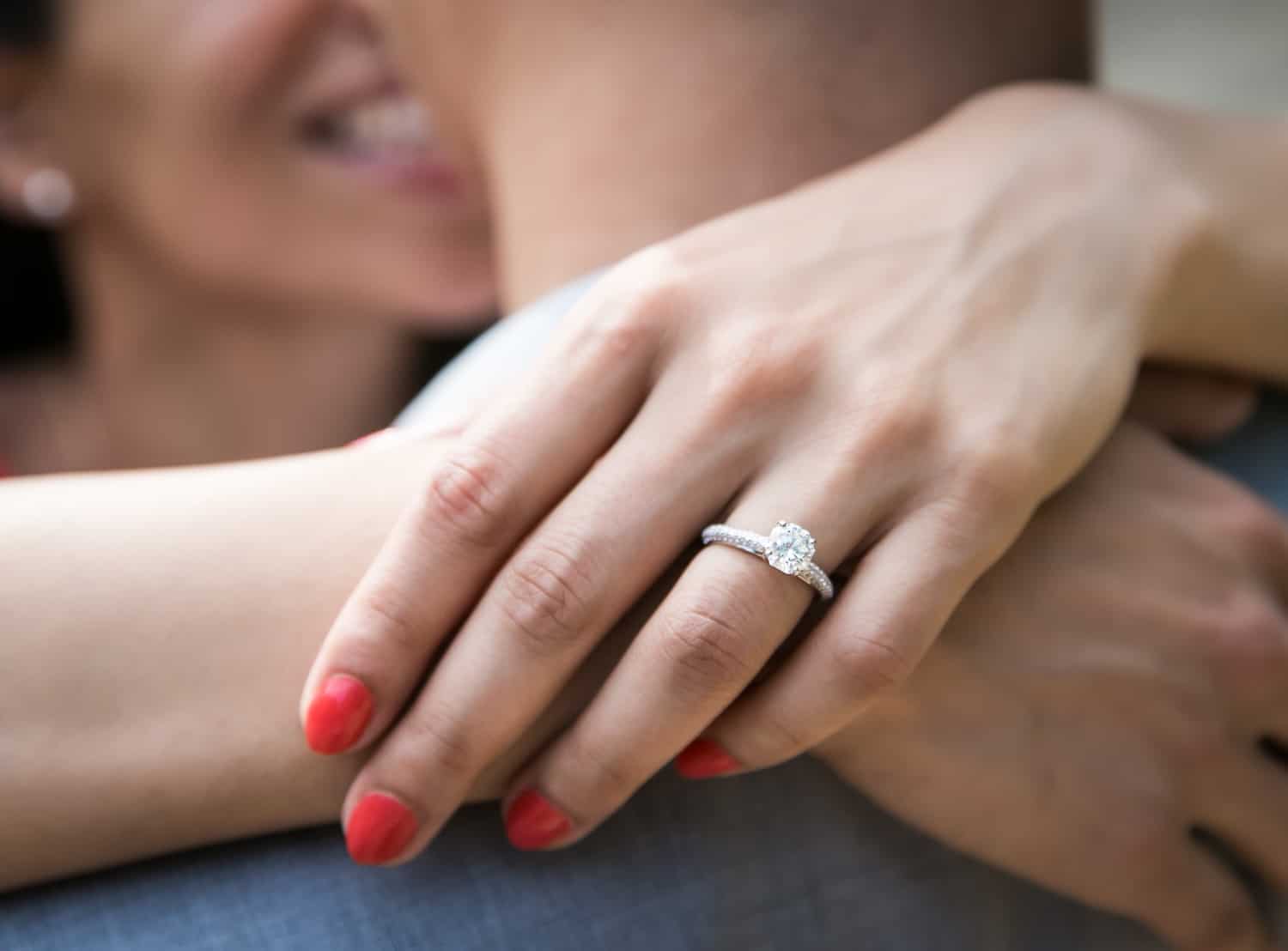 Close up of woman's hand wearing engagement ring