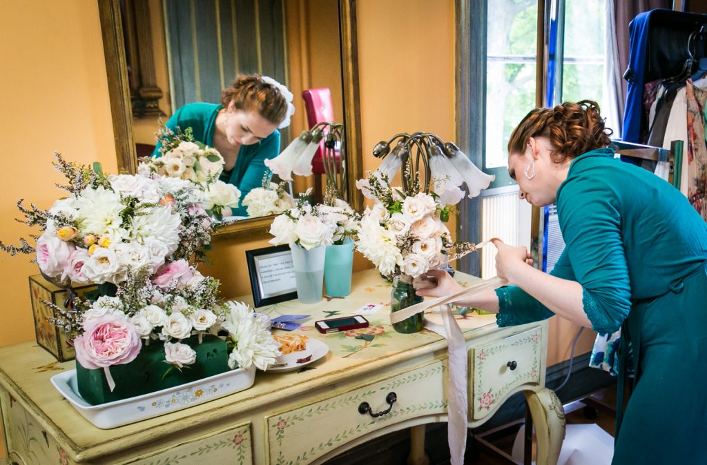 Bride creating her bouquet at a Round Hill House wedding