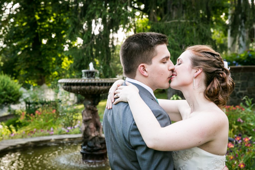 Bride and groom kissing in garden at a Round Hill House wedding