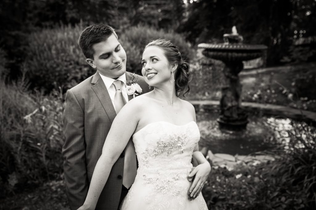 Black and white photo of bride and groom in garden