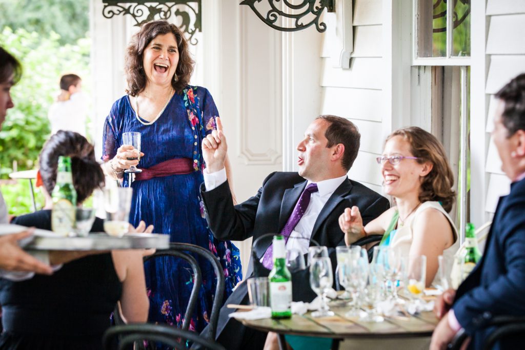 Guests on patio enjoying cocktail hour at a Round Hill House wedding