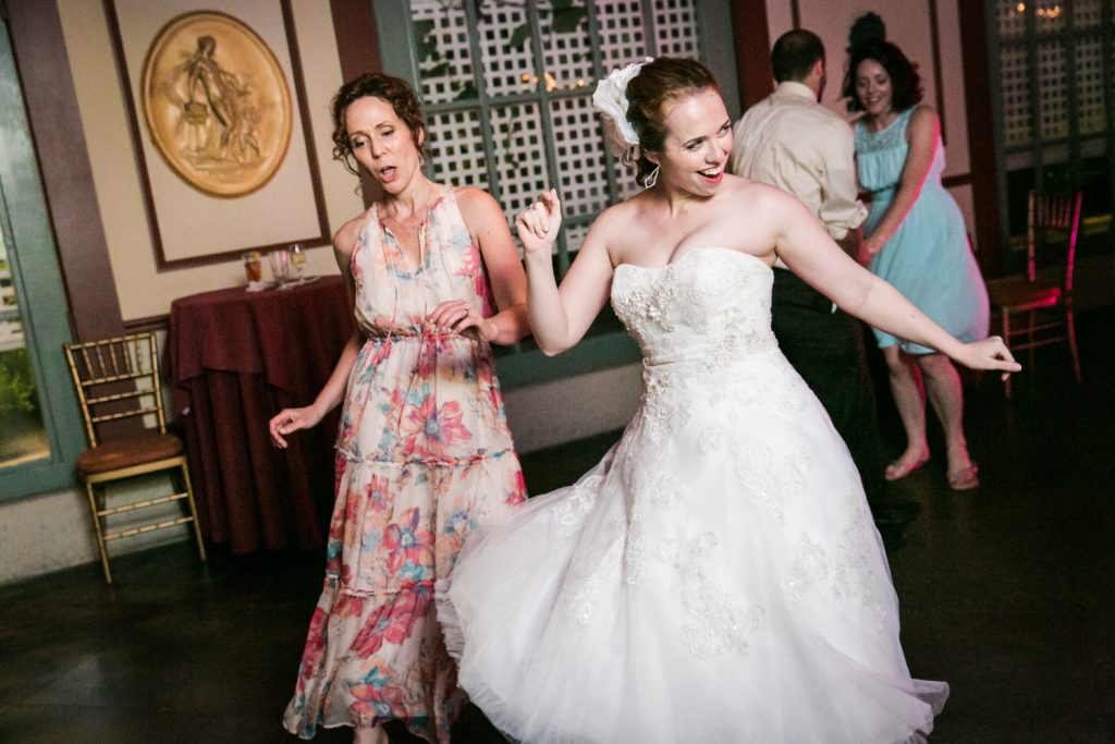 Bride and mother dancing during reception