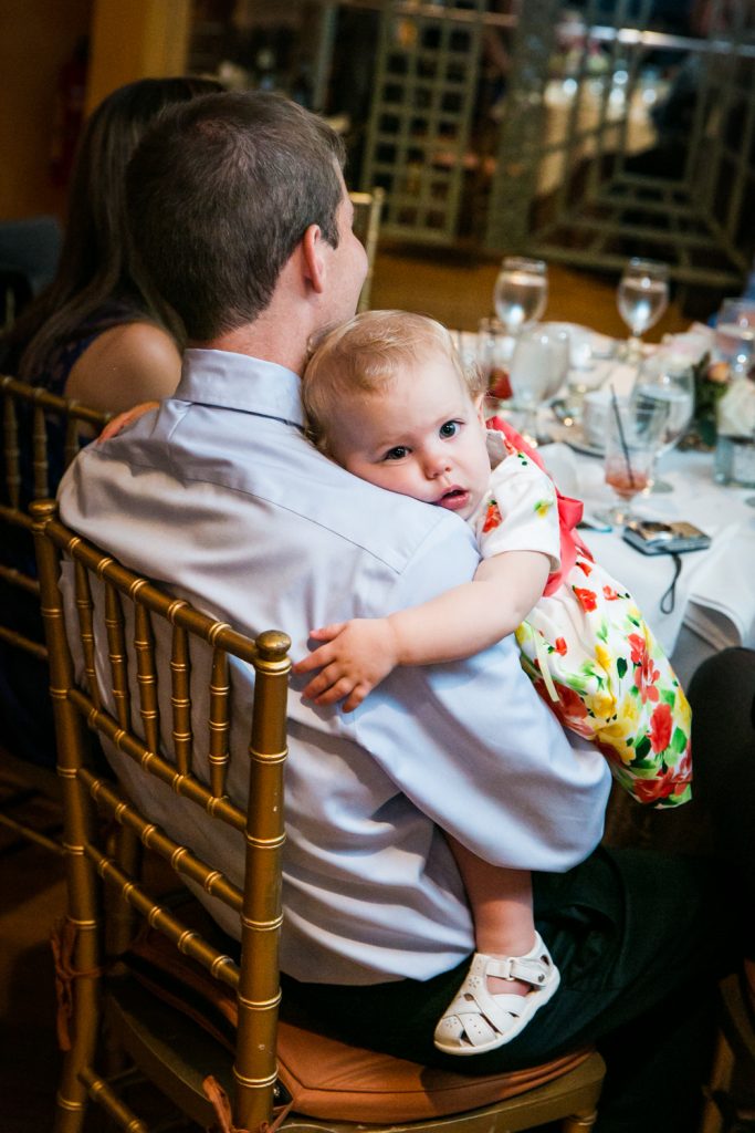 Baby laying on father's shoulder at a Round Hill House wedding