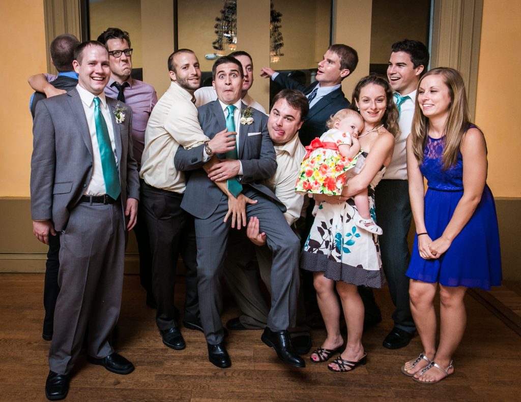 Bride and groom clowning around with friends at a Round Hill House wedding
