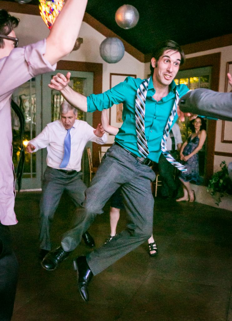 Guest jumping in the air on the dance floor