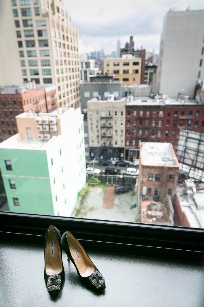 High heels in windowsill with NYC skyline in background
