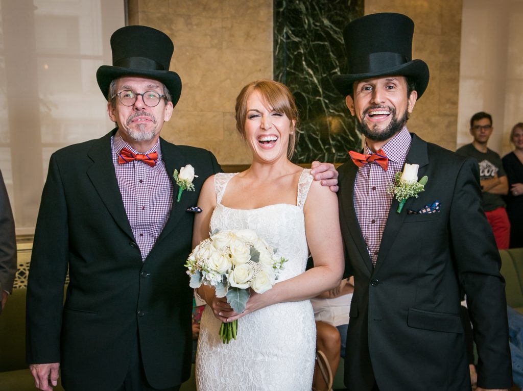 NYC City Hall wedding photos of bride with two men wearing top hats