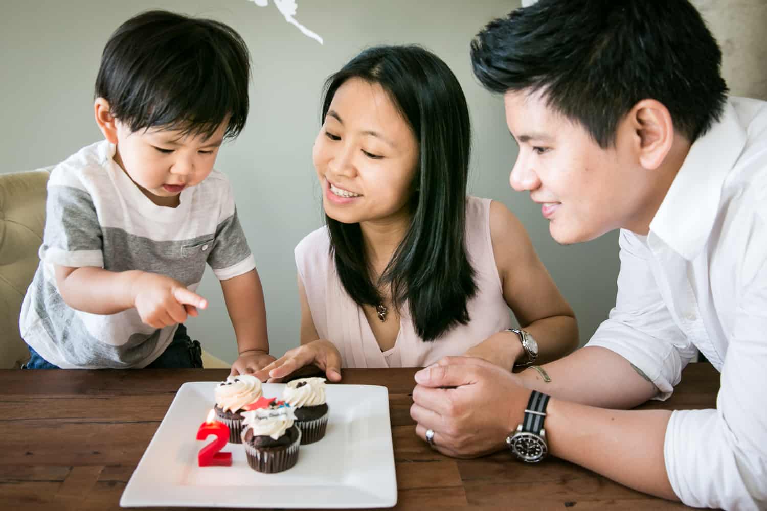 Manhattan family portrait of parents and child eating cupcakes