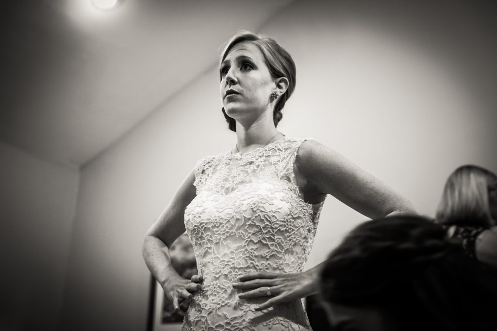 Black and white photo of bride with hands on hips