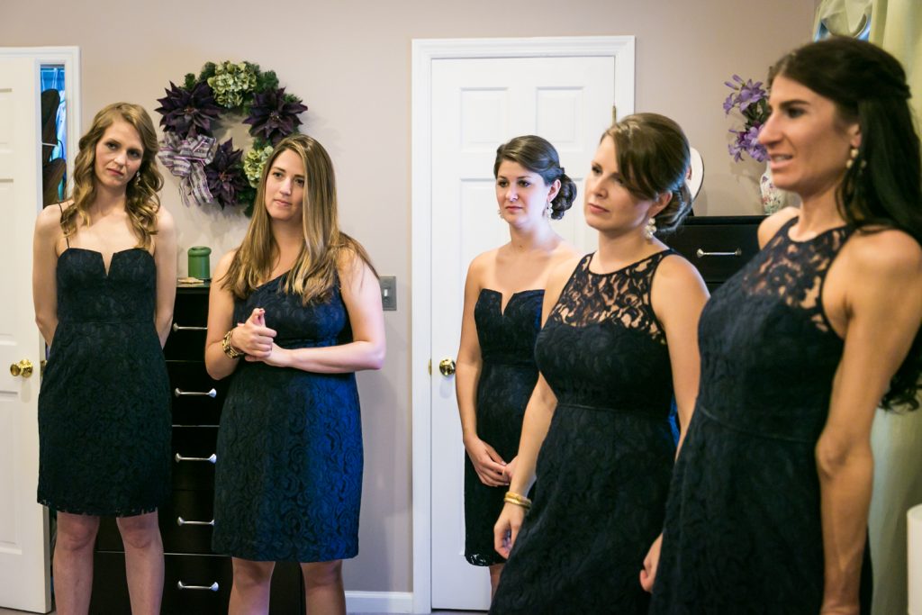 Bridesmaids in black dresses watching 