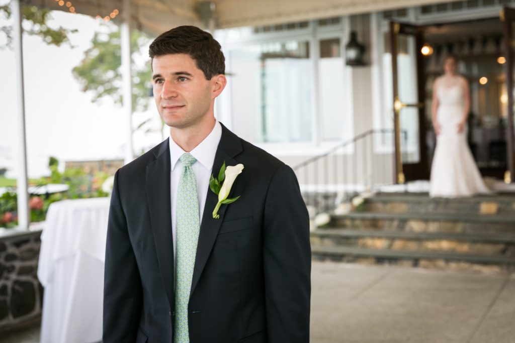 Groom waiting for bride during first look at an American Yacht Club wedding