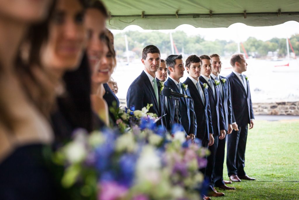 Bridal party in a line with groom looking for bride at an American Yacht Club wedding