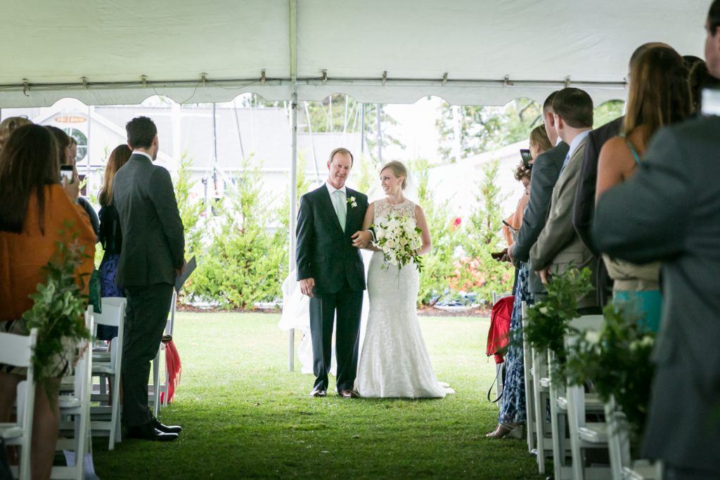 Bride and father at end of aisle during ceremony at an American Yacht Club wedding