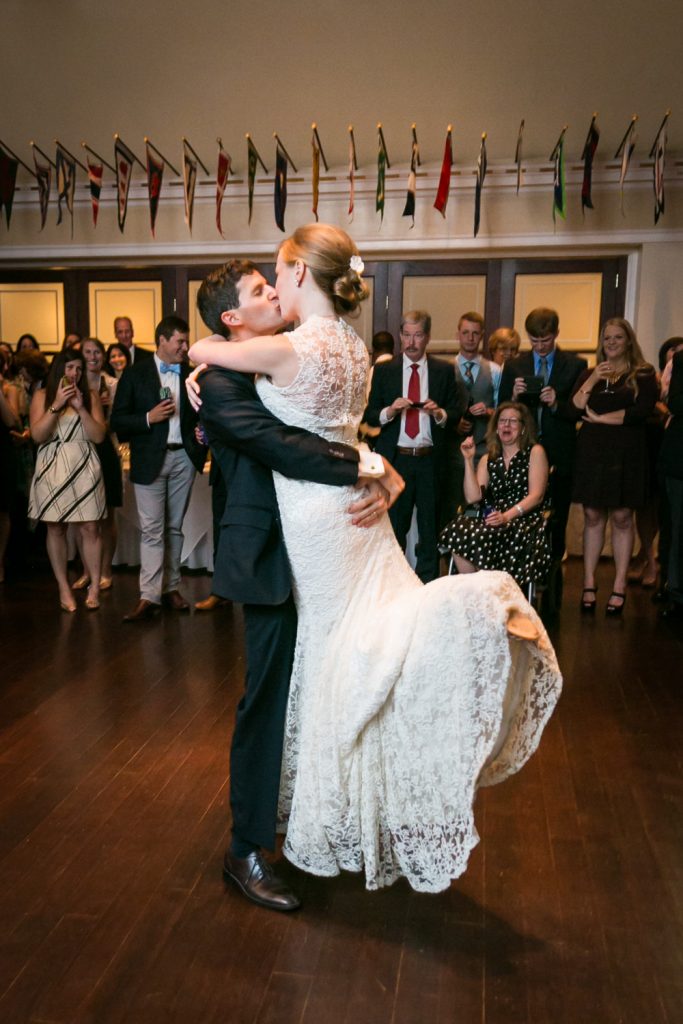 Groom lifting bride during first dance at an American Yacht Club wedding