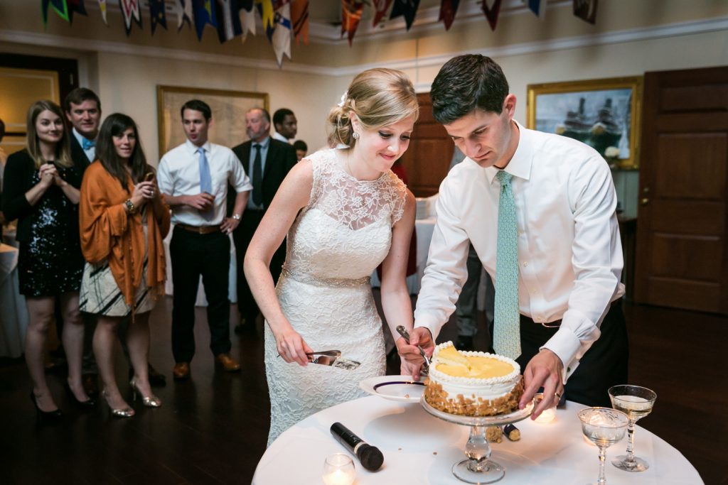 Bride and groom cutting cake at an American Yacht Club wedding