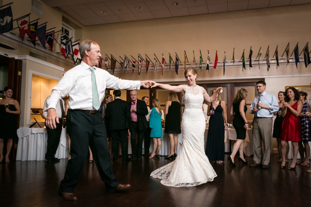 Bride dancing with father with arms outstretched