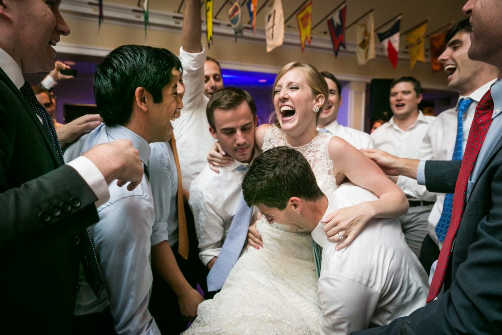 Bride lifted in the air by guests 