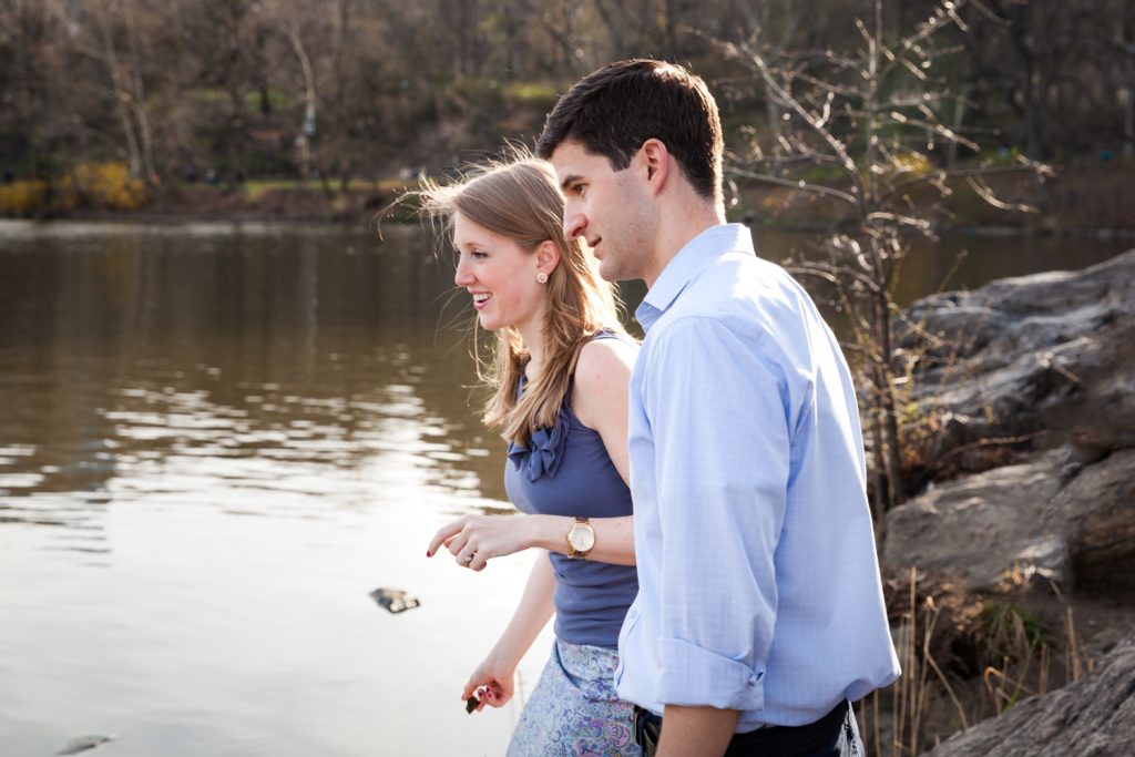 Couple skipping stones in Central Park lake