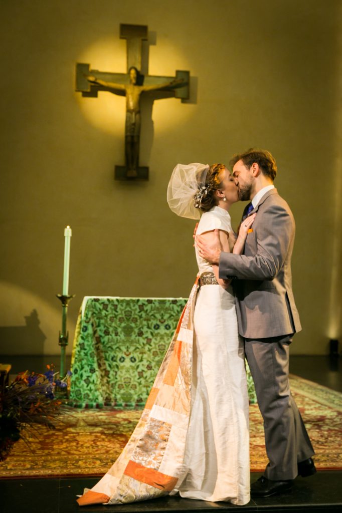 Bride and groom kissing at altar during Oratory of St. Boniface ceremony