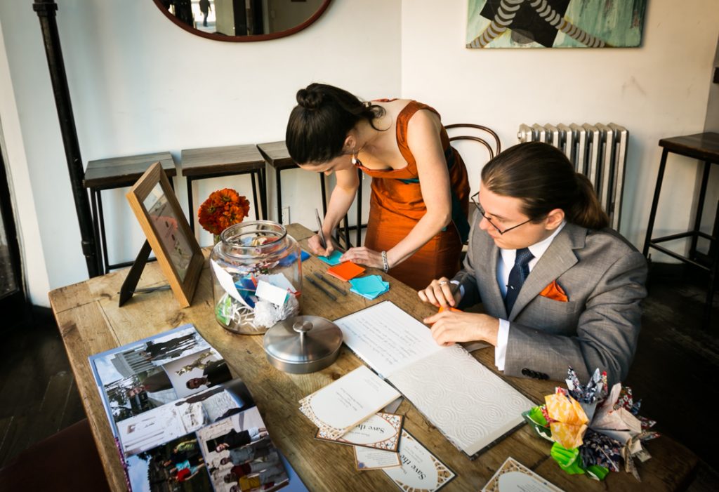 Man and woman making guest book at a Farm on Adderley wedding