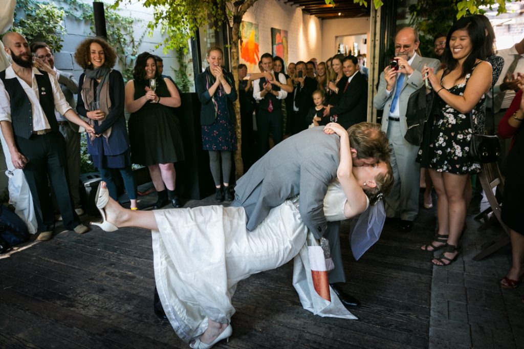Groom and bride kissing on dance floor during Farm on Adderley wedding reception