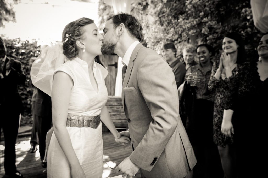 Black and white photo of bride and groom kissing during Farm on Adderley wedding reception