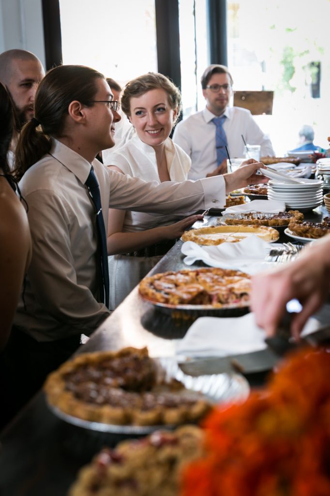 Bride and guests in front of pies during Farm on Adderley wedding reception