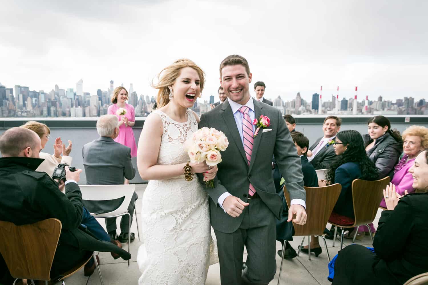 Bride and groom recessing from rooftop wedding ceremony