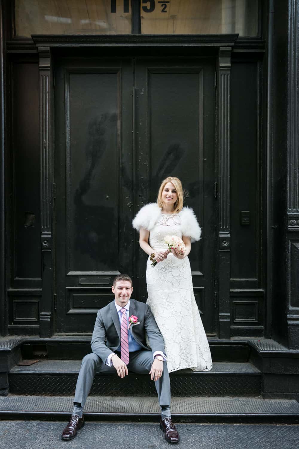 Bride and groom posed on stoop in Soho
