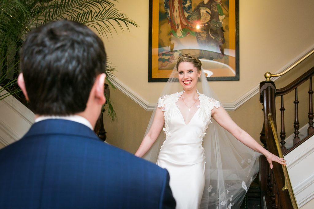 Bride walking down stairs to groom for the first time