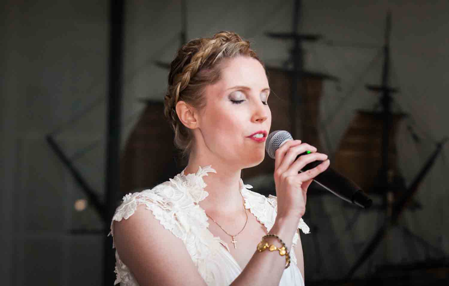 Bride singing with eyes closed at an India House wedding