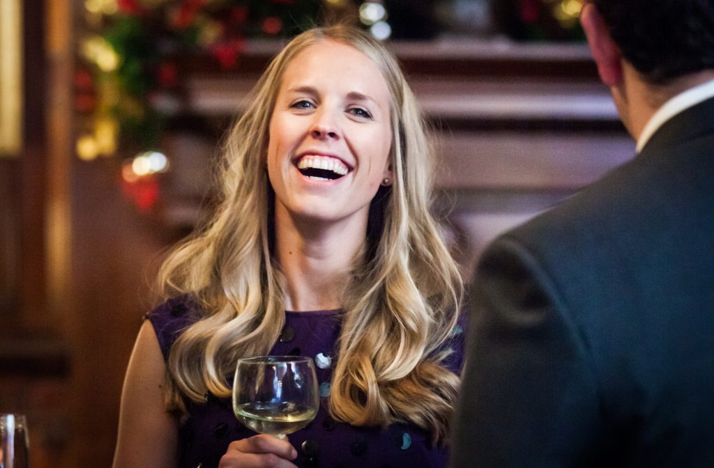 Woman with blonde hair laughing at a Lotos Club engagement party