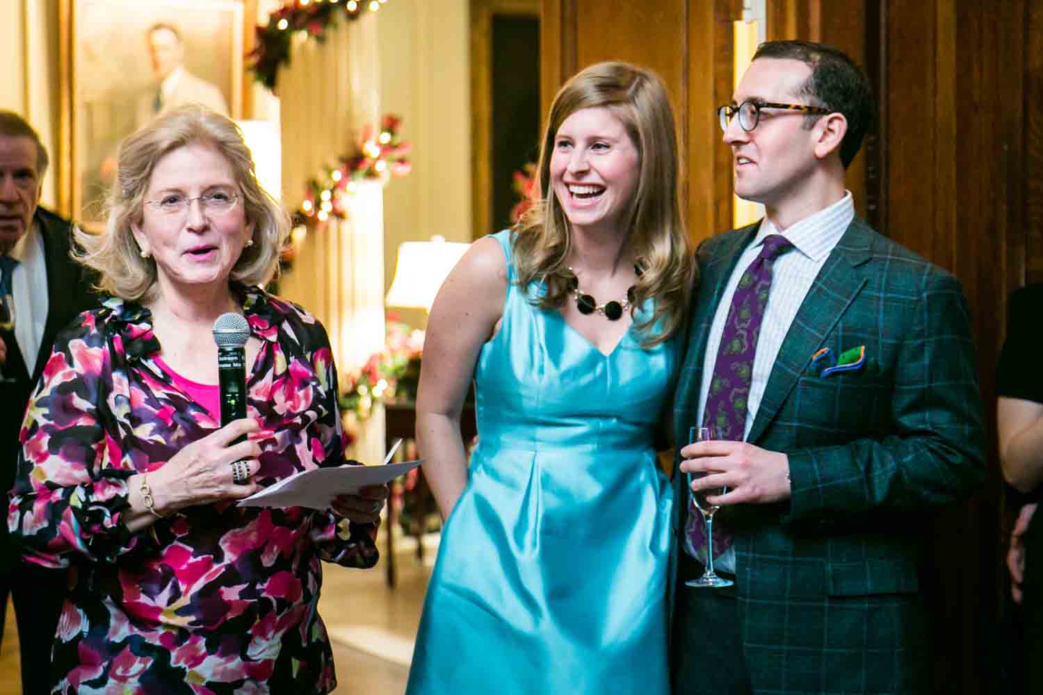 Mother of the groom making a speech in front of couple at a Lotos Club engagement party