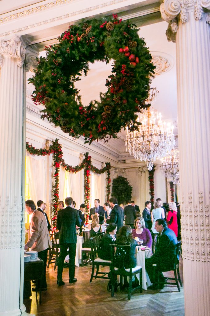 Christmas wreath between two columns in lobby of Lotos Club