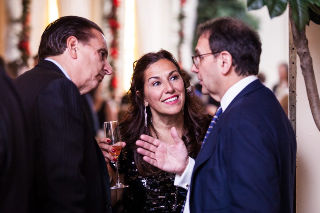 Three guests talking at a Lotos Club engagement party