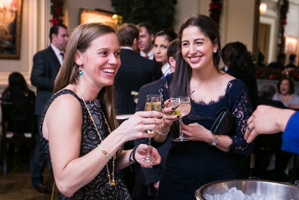 Two female guests holding wine glasses at a Lotos Club engagement party